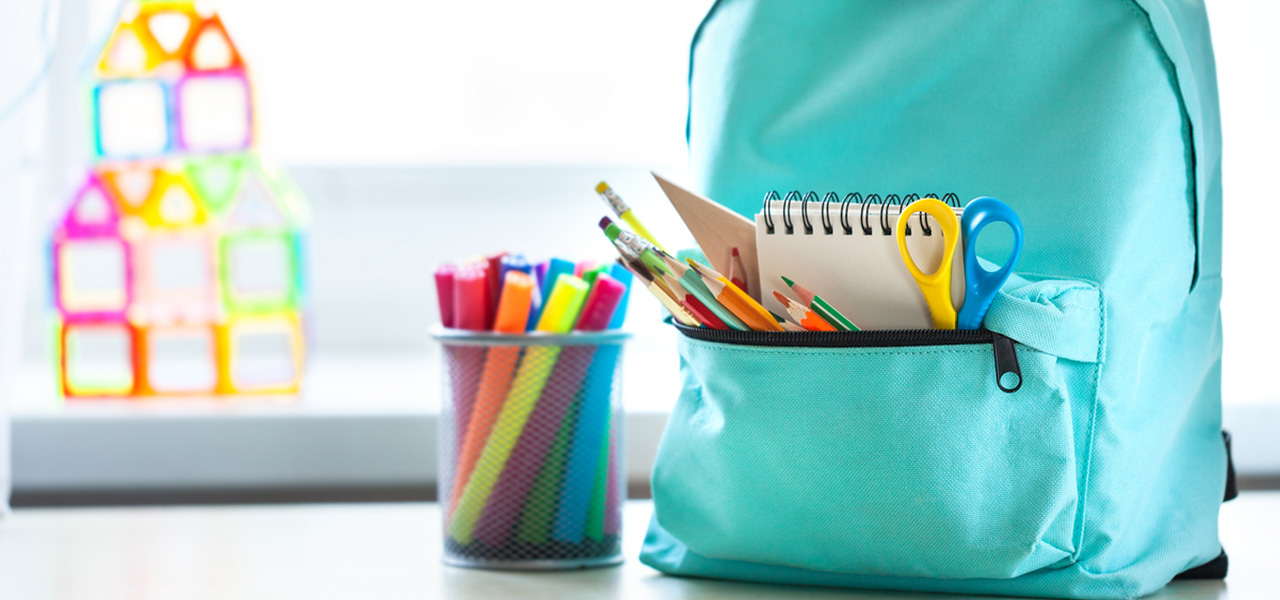 Hundreds of donated backpacks given to school children