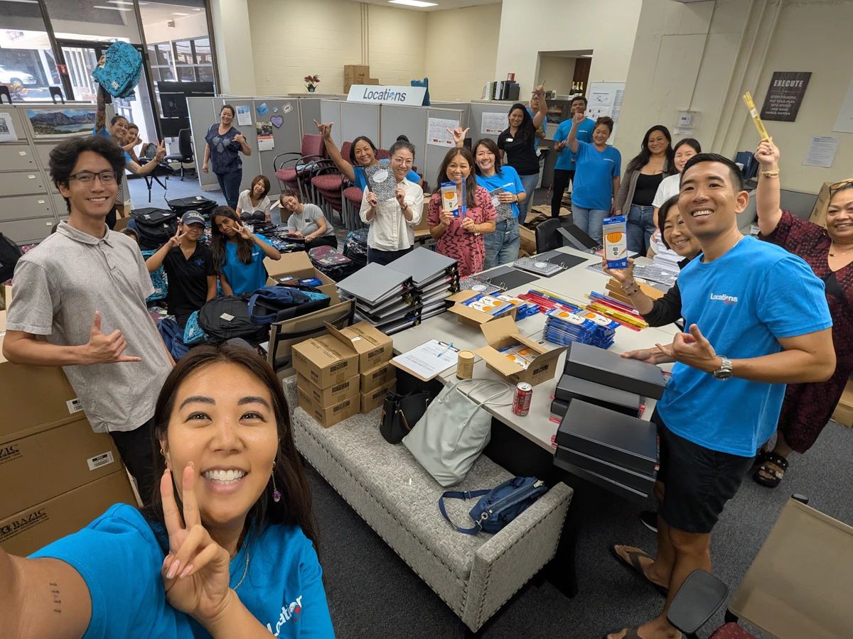 Locations Foundation Backpack to School Drive volunteers preparing backpacks for Hawaii students