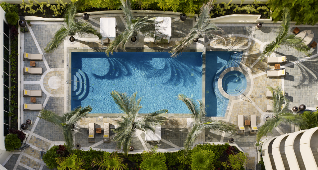 Allure Waikiki pool deck view with palm trees